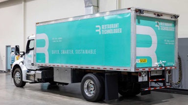 Truck with the title Restaurant Technologies sitting in a garage